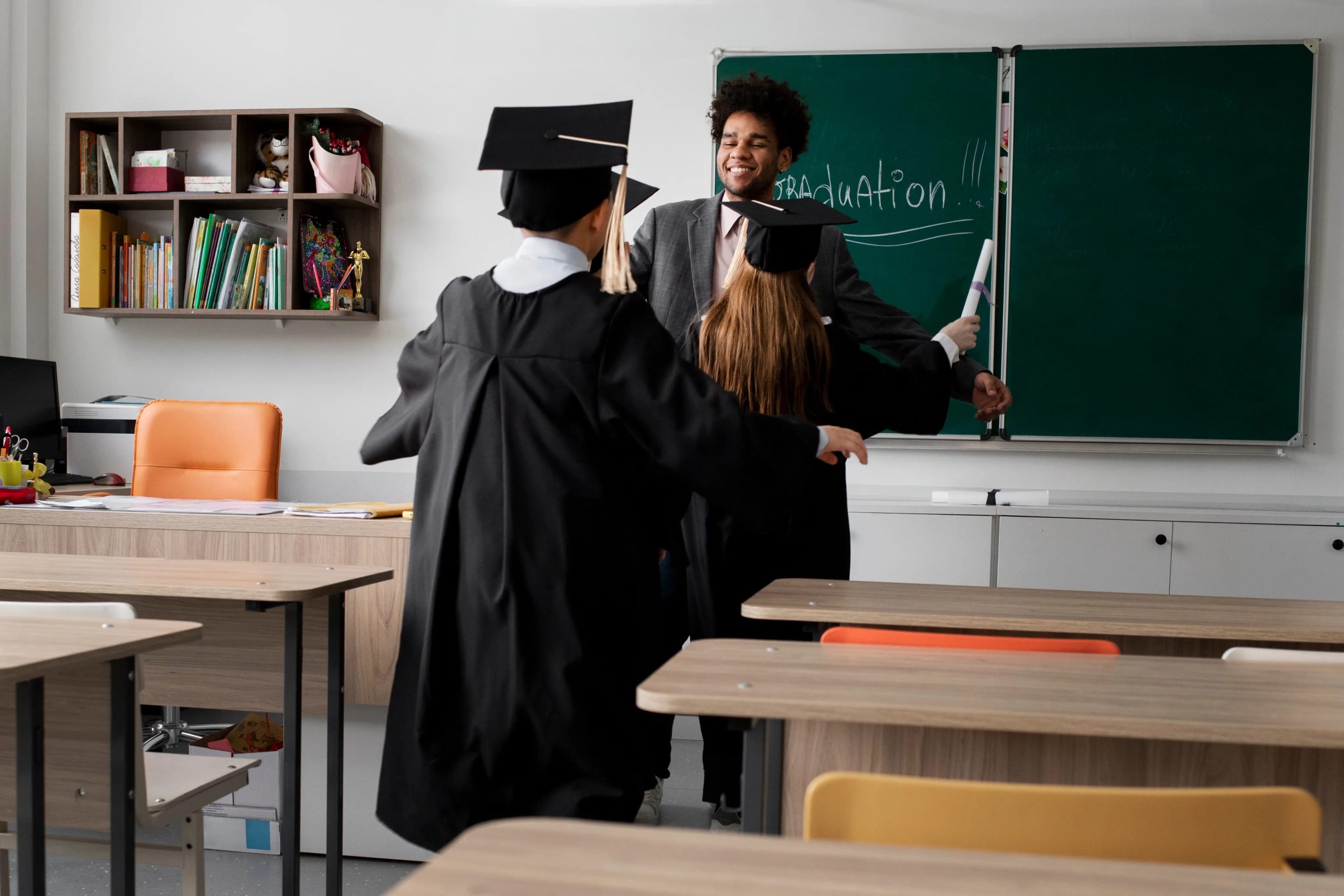 Students celebrating graduation with teacher